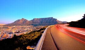 Beautiful view of Table Mountain in Cape Town from Signal Hill and some light streeks from cars.